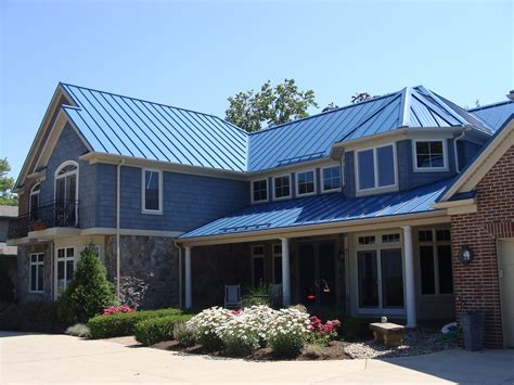 matching metal blue roof and door stone house|blue roof exterior home ideas.